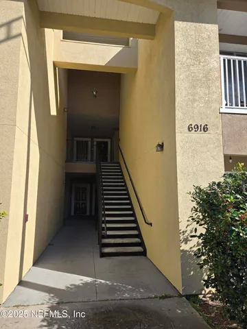 a view of a hallway with wooden walls and staircase