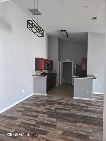 a view of kitchen with cabinets and wooden floor