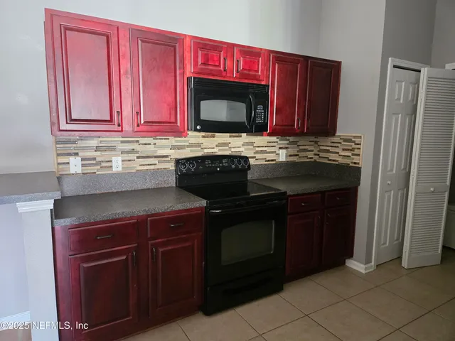 a kitchen with stainless steel appliances granite countertop a stove and a microwave