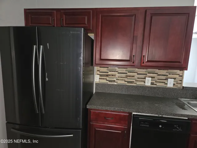 a kitchen with a refrigerator and cabinets