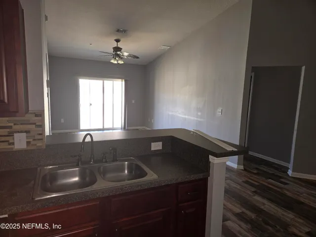 a kitchen that has a sink and a stove with granite countertops