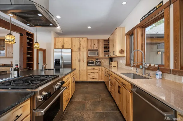 a kitchen with stainless steel appliances granite countertop a stove and a sink