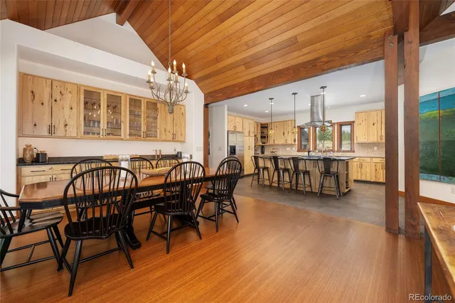 a dining room with furniture and wooden floor