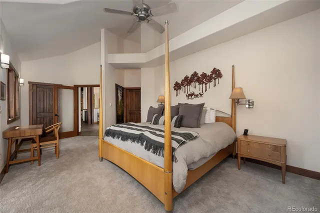 a spacious bedroom with a bed and a chandelier