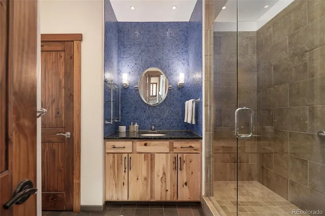 a bathroom with a sink a mirror and shower