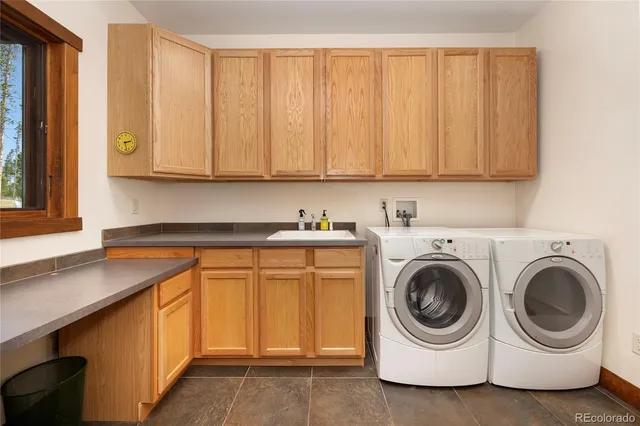a utility room with sink dryer and washer