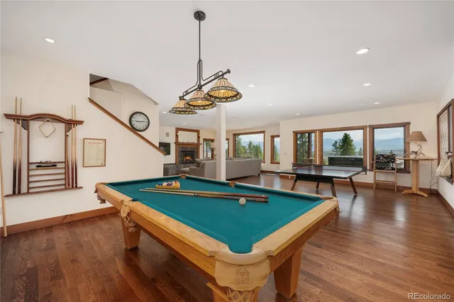 a view of a work space with wooden floor and a floor to ceiling window