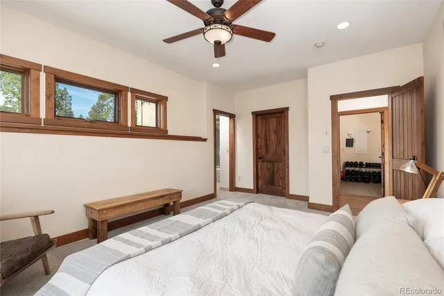 a bathroom with a granite countertop toilet a sink a mirror and bathtub
