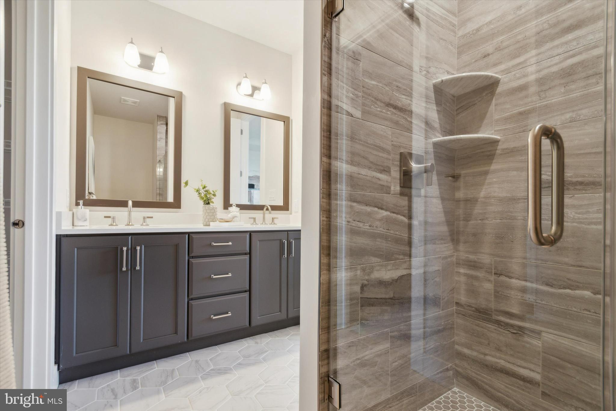 482 Mustang Road, Unit 359 Downingtown, PA 19335 - Photo 8 of 38 a bathroom with a double vanity sink a toilet a mirror and shower
