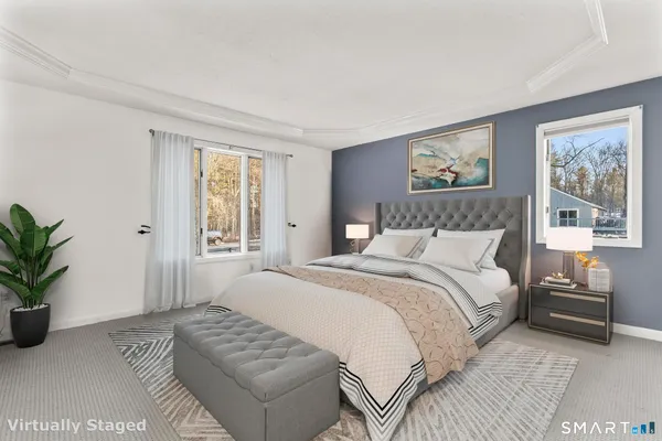 a bedroom with a large bed and a couch