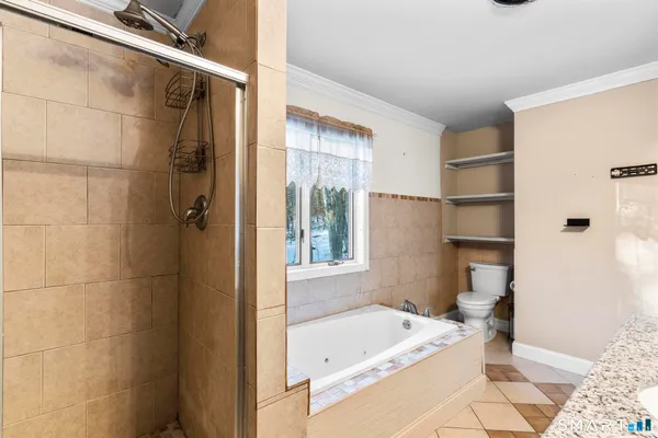 a bathroom with a tub shower and sink