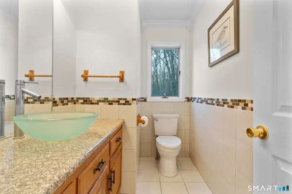 a bathroom with a granite countertop sink a toilet and a tub