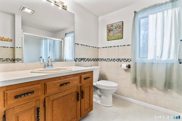 a bathroom with a sink a toilet and a mirror