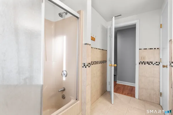 a bathroom with a shower and a glass door