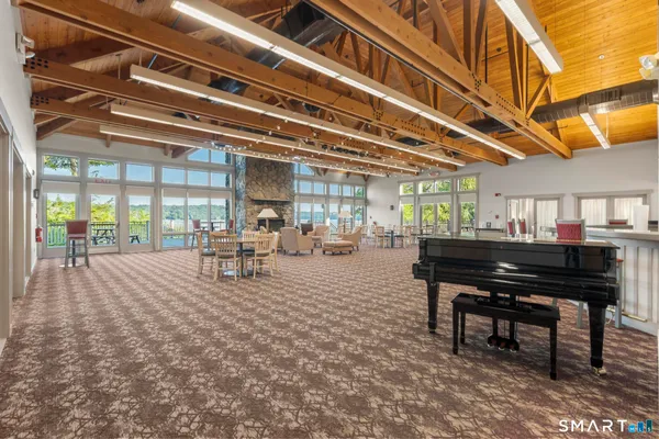 a living room with furniture and a piano