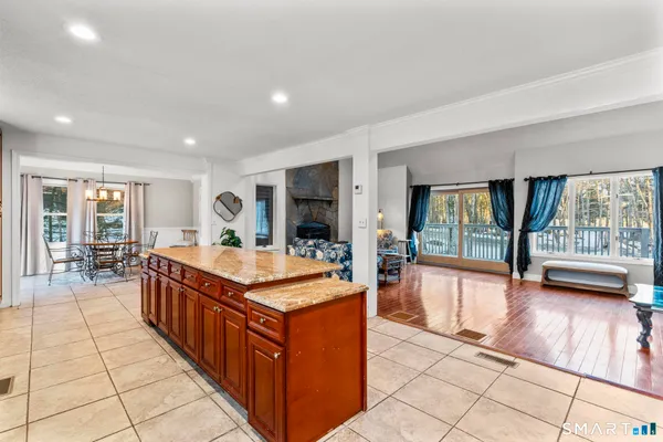 a large kitchen with kitchen island granite countertop a large stove a sink and a large window