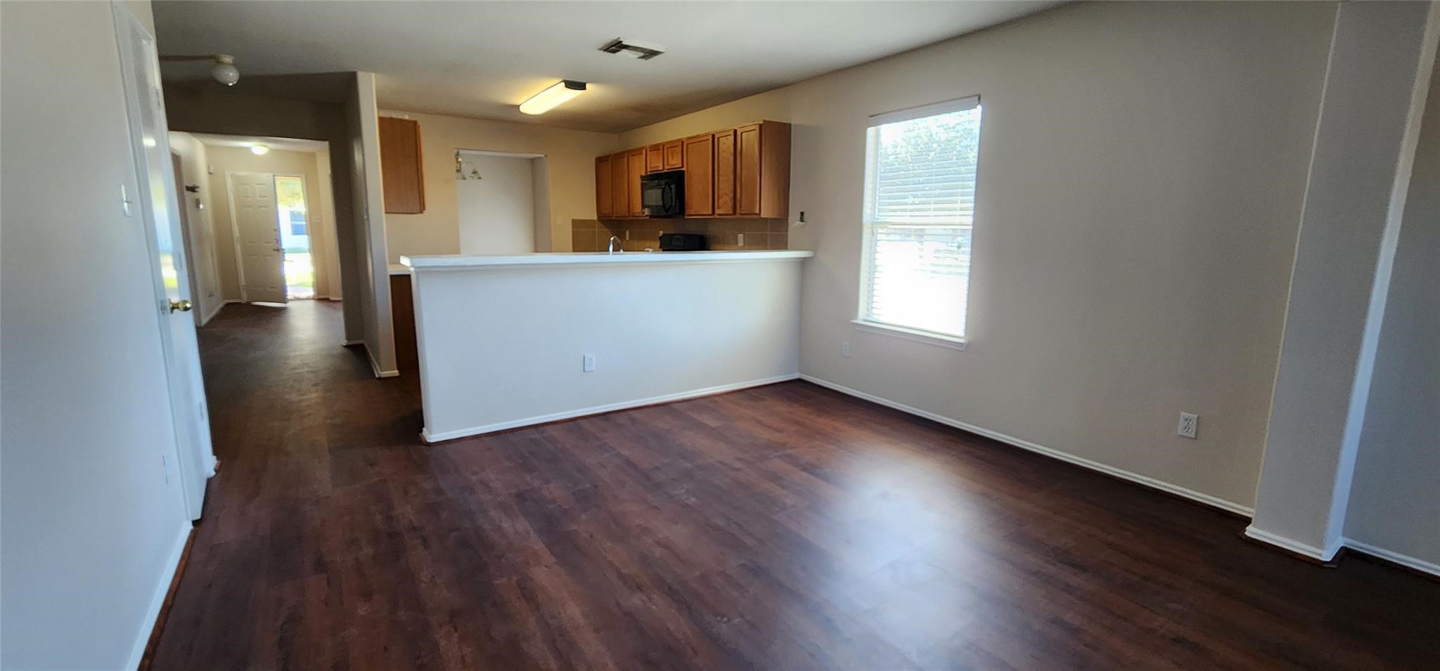 315 Sunset Colony Drive Rosharon, TX 77583 - Photo 7 of 20 a view of a kitchen with wooden floor and a window