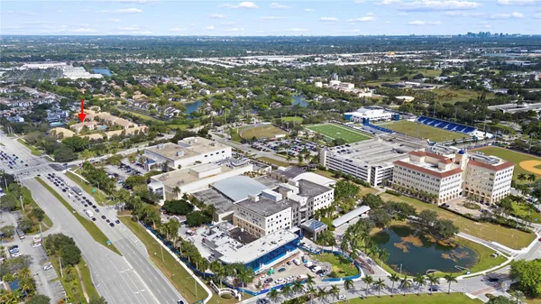 an aerial view of residential building with parking