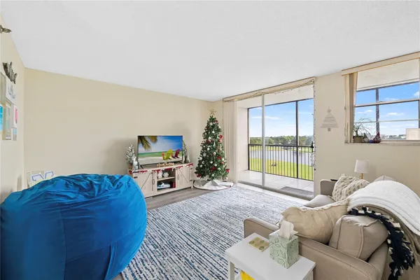 a living room with furniture window and a flat screen tv