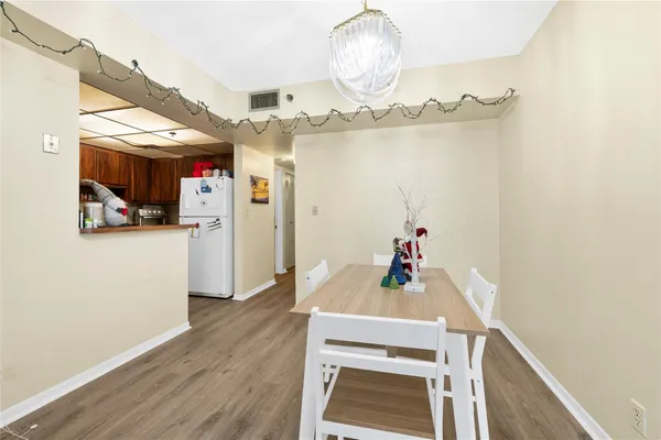 a view of a dining room with furniture wooden floor and a chandelier