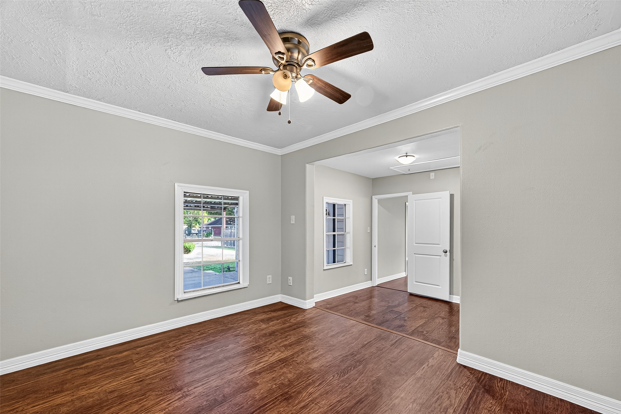 4034 Caplin Street Houston, TX 77026 - Photo 22 of 37 a view of an empty room with wooden floor and a window