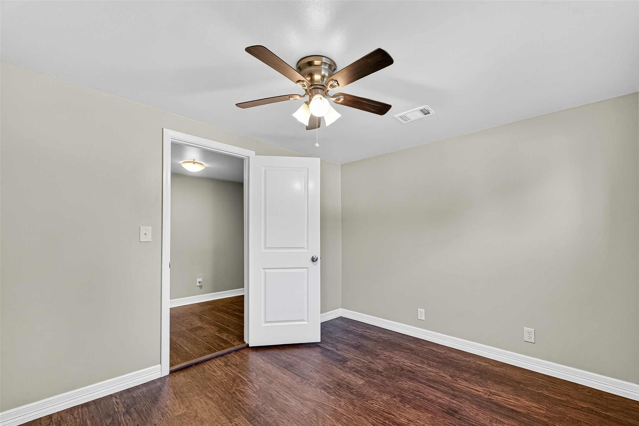 4034 Caplin Street Houston, TX 77026 - Photo 25 of 37 an empty room with wooden floor and ceiling fan