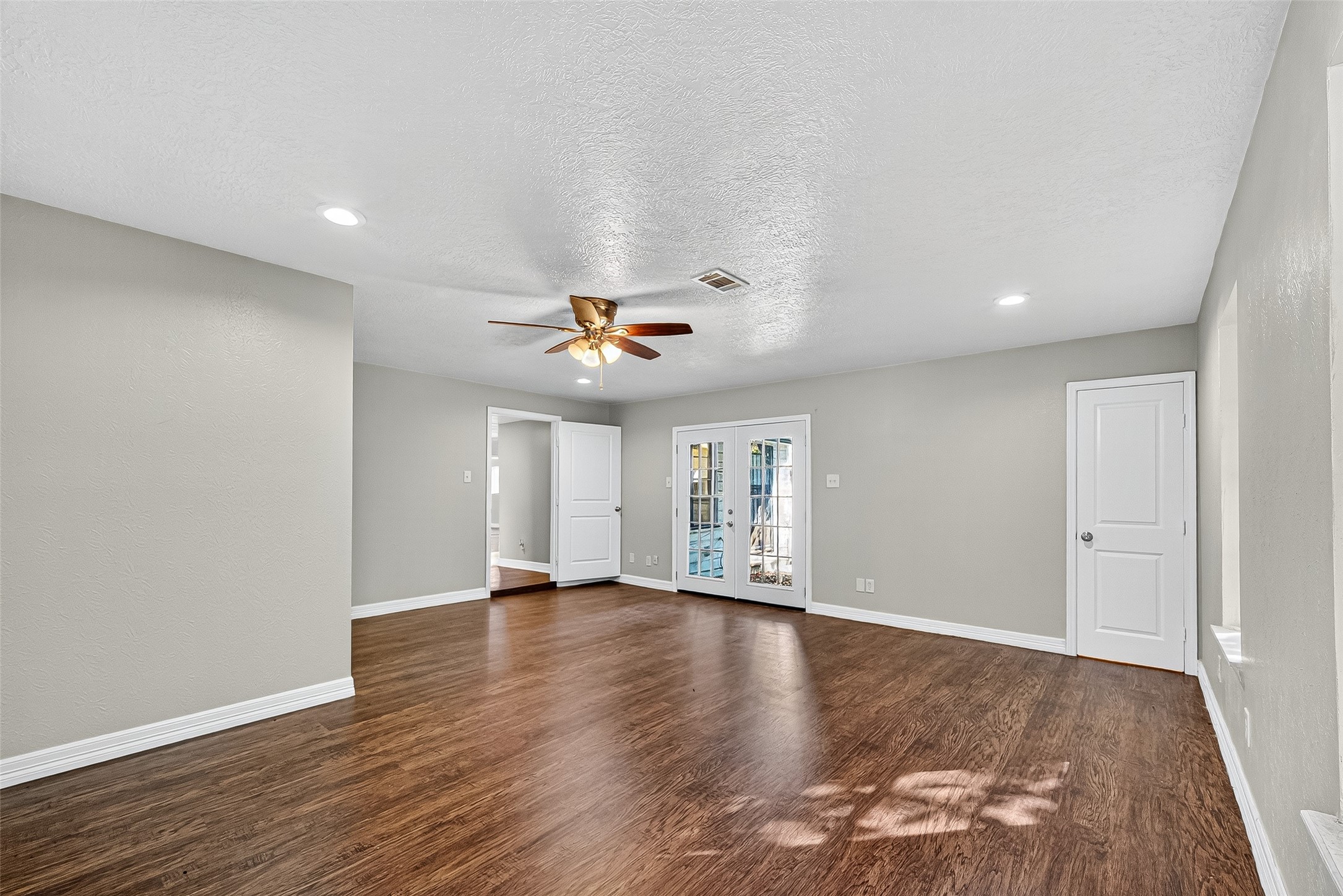 4034 Caplin Street Houston, TX 77026 - Photo 30 of 37 a view of an empty room with window and wooden floor