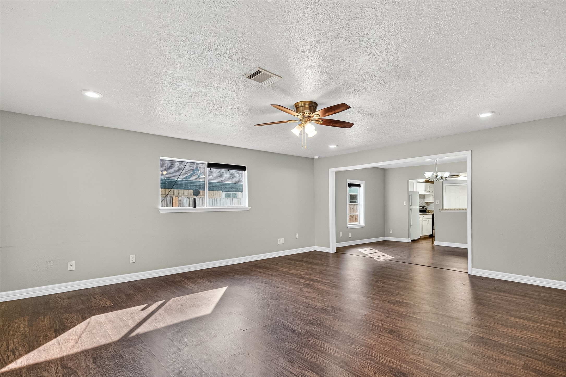 4034 Caplin Street Houston, TX 77026 - Photo 10 of 37 a view of an empty room with window and wooden floor