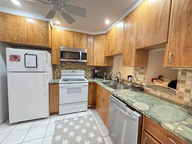 a kitchen with a stove a sink and a microwave