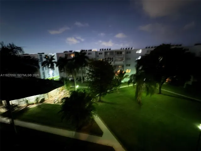 a view of a lake in front of residential house with outdoor space