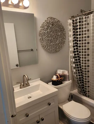 a bathroom with a sink a toilet and a shower