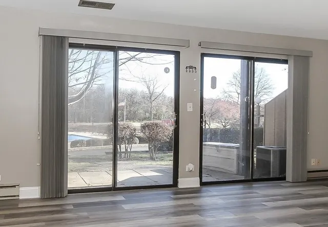 a view of front door and wooden floor