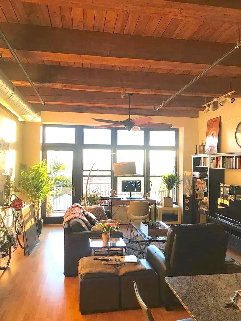 1503 South State Street, Unit 503 Chicago, IL 60605 - Photo 3 of 5 a living room with furniture and a large window