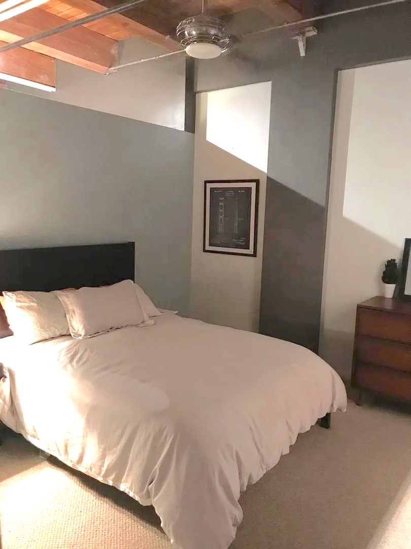 1503 South State Street, Unit 503 Chicago, IL 60605 - Photo 4 of 5 a bedroom with a bed and a chandelier