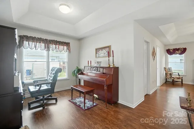 a view of a workspace with furniture and a window
