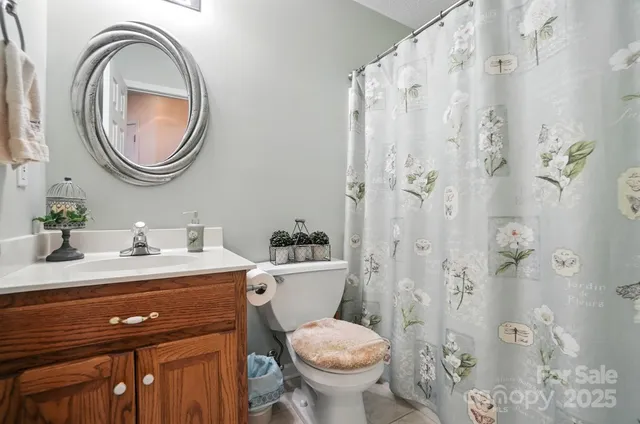 a bathroom with a sink a toilet and a mirror