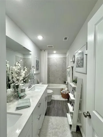 a spacious bathroom with a double vanity sink and a mirror
