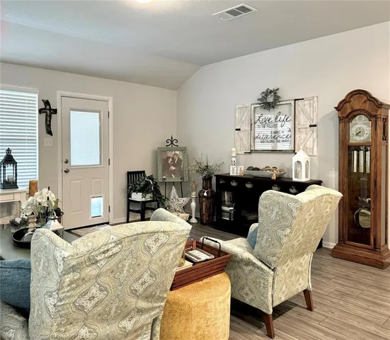 a living room with furniture and large windows