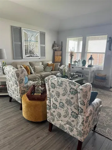 a living room with furniture window and wooden floor