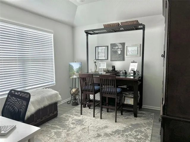 a dining room with furniture and window