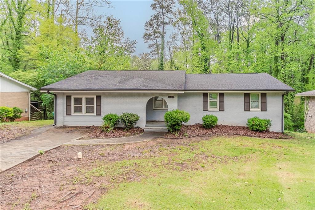 2682 Cavalier Drive Decatur, GA 30034 - Photo 1 of 1 a front view of a house with a garden and porch