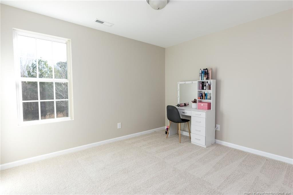 325 Ray Byrd Road Lillington, NC 27546 - Photo 14 of 26 an empty room with windows