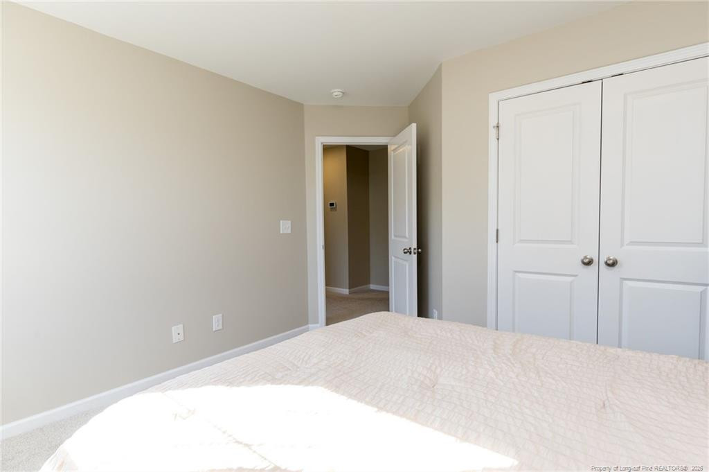 325 Ray Byrd Road Lillington, NC 27546 - Photo 17 of 26 a bedroom with a bed and a window