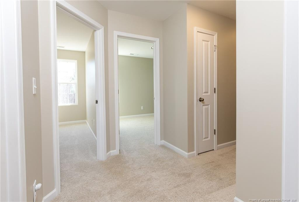 325 Ray Byrd Road Lillington, NC 27546 - Photo 23 of 26 a view of a hallway with wooden floor