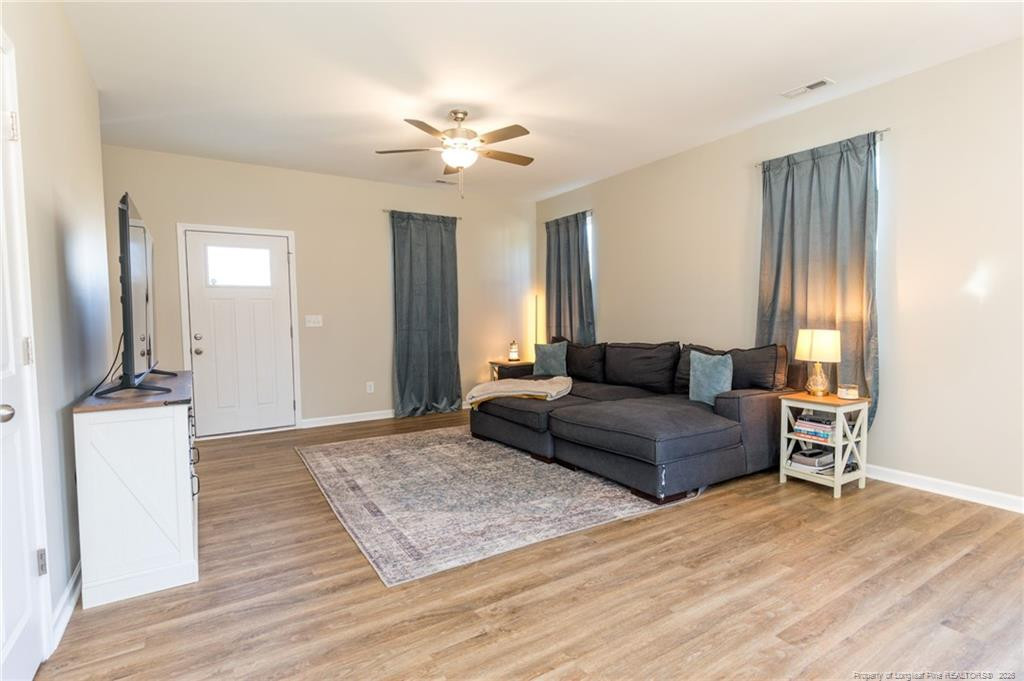 325 Ray Byrd Road Lillington, NC 27546 - Photo 6 of 26 a living room with furniture and a wooden floor