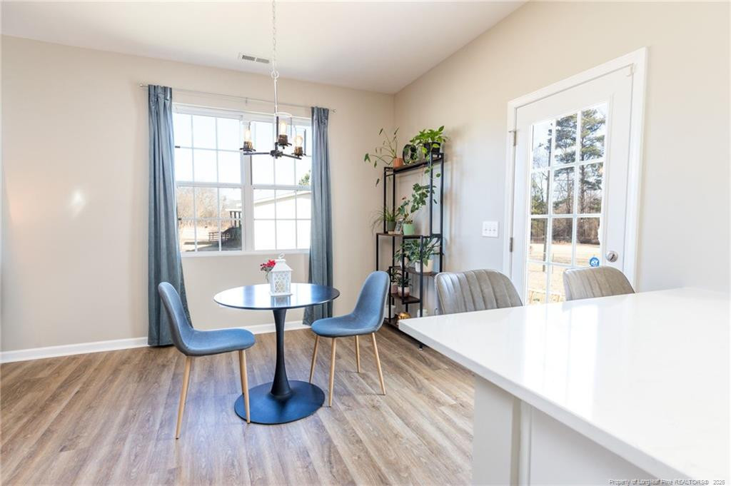 325 Ray Byrd Road Lillington, NC 27546 - Photo 7 of 26 a living room with furniture and a wooden floor
