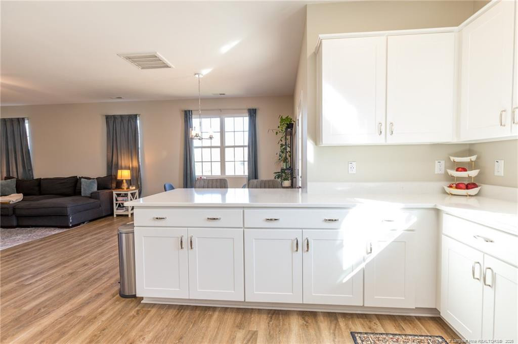 325 Ray Byrd Road Lillington, NC 27546 - Photo 10 of 26 a kitchen with a sink cabinets and wooden floor