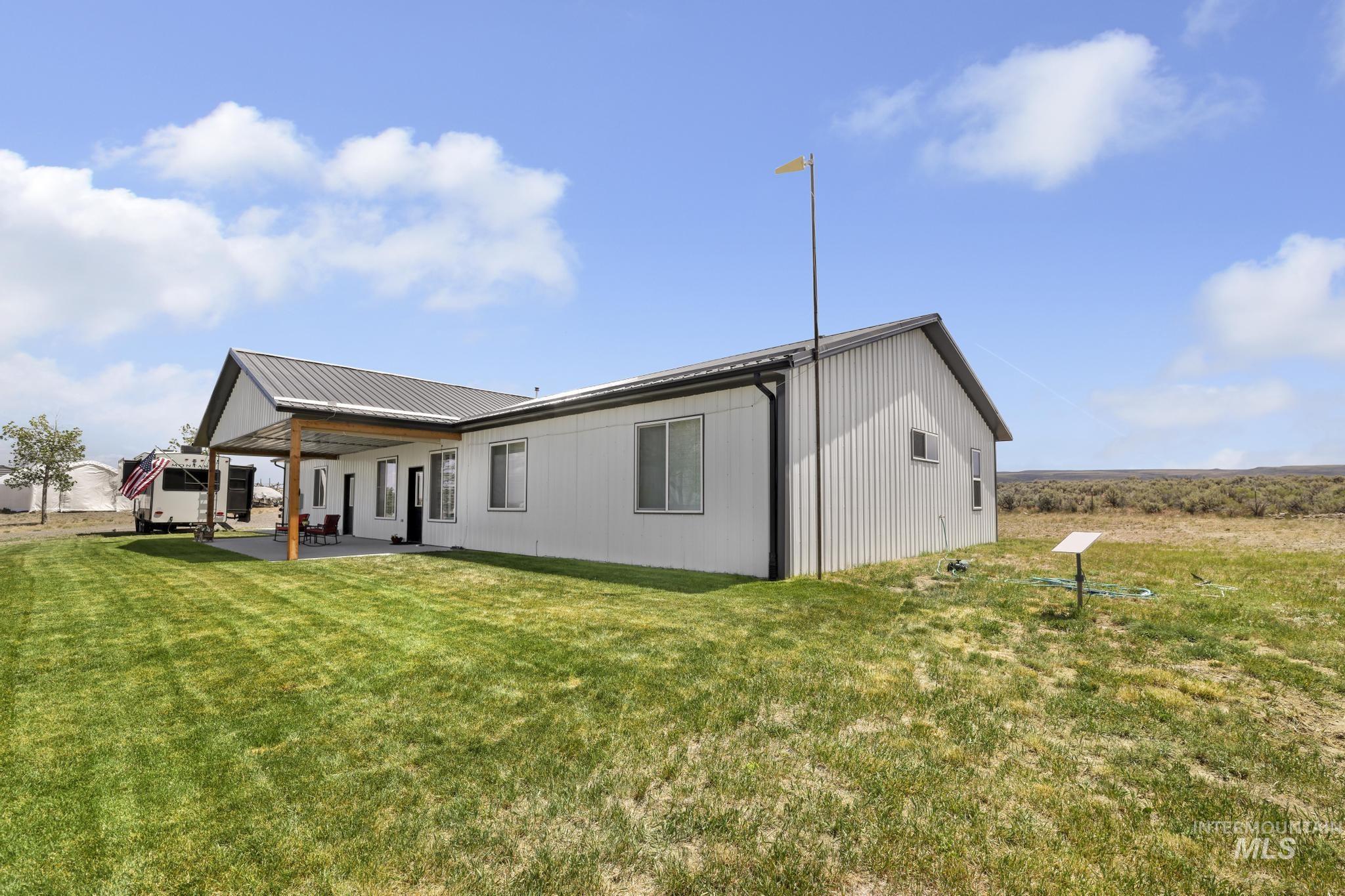 758 Cedar Crk Road Rogerson, ID 83302 - Photo 33 of 50 Contemporary farmhouse exterior featuring light-colored siding and a dark metal roof
