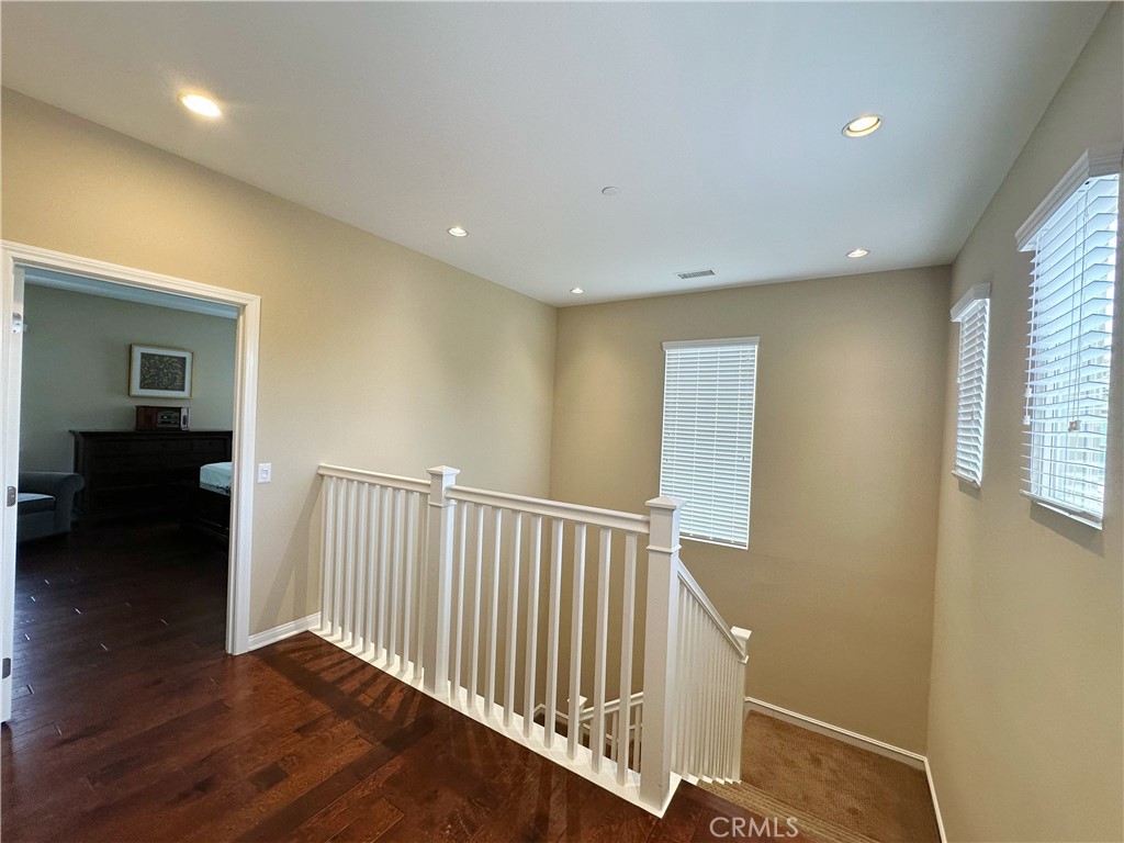 65 Elmdale Irvine, CA 92620 - Photo 2 of 8 a view of hallway with wooden floor and stairs