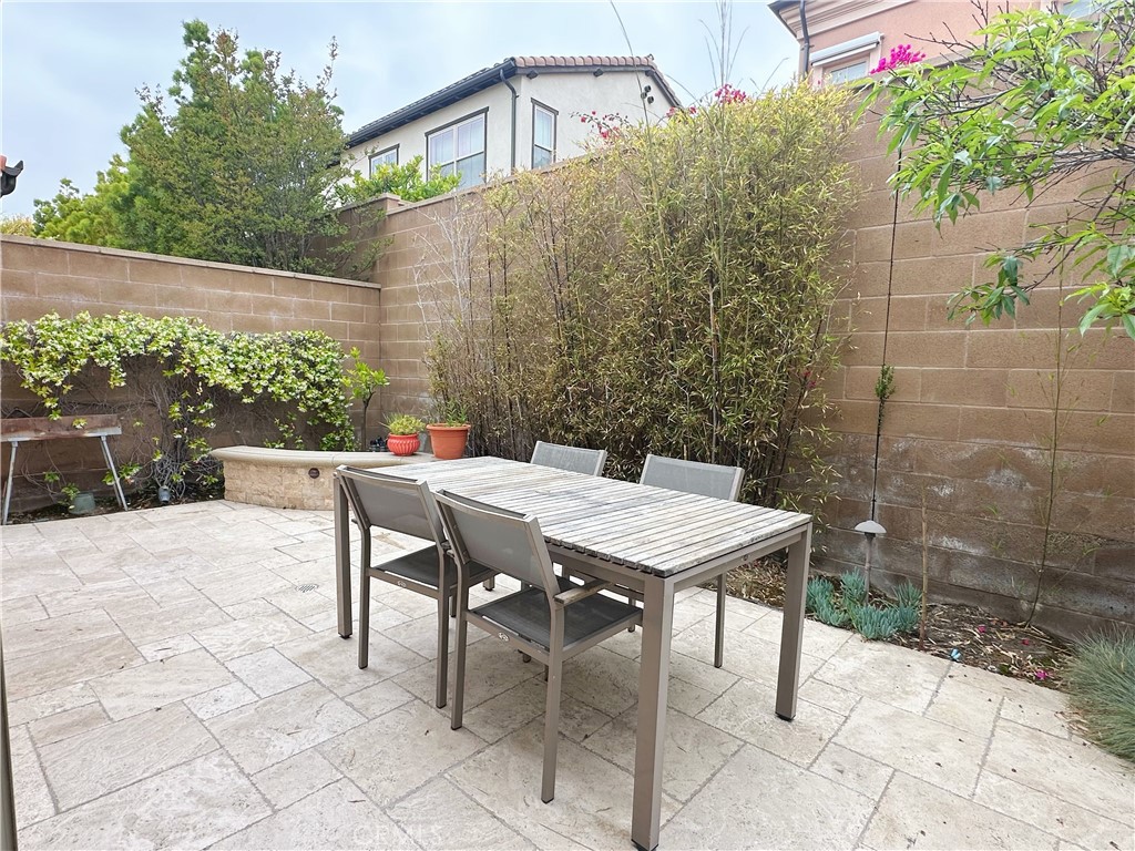 65 Elmdale Irvine, CA 92620 - Photo 3 of 8 a view of a patio with table and chairs and potted plants